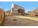 A large, fully fenced backyard featuring a patio, screened porch, and play area at 5305 Redfield Way, Cumming, GA 30028