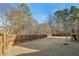 A beautiful fenced backyard with mature trees, offering privacy and a serene outdoor space at 5305 Redfield Way, Cumming, GA 30028