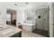 Bright bathroom featuring a modern tub, glass enclosed shower and an open doorway at 5305 Redfield Way, Cumming, GA 30028