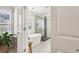 Bright bathroom featuring a modern tub, glass enclosed shower and leafy green plant at 5305 Redfield Way, Cumming, GA 30028