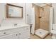 Modern bathroom featuring a tiled walk-in shower, a white vanity, and a framed mirror at 5305 Redfield Way, Cumming, GA 30028