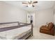 Inviting bedroom featuring neutral walls, twin beds with guardrails, and a comfortable leather chair at 5305 Redfield Way, Cumming, GA 30028