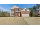 Traditional two-story home with manicured lawn and inviting curb appeal at 5305 Redfield Way, Cumming, GA 30028