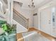 Inviting foyer with a staircase, hardwood floors, and a white front door and sidelights at 5305 Redfield Way, Cumming, GA 30028