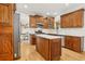 Spacious kitchen with wood cabinetry, a center island, and stainless steel appliances, great for entertaining at 5305 Redfield Way, Cumming, GA 30028