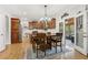 Open-concept kitchen with a large island, wood cabinets, stainless steel appliances, and access to the patio at 5305 Redfield Way, Cumming, GA 30028