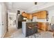 Stylish kitchenette with wooden cabinets, granite countertops, an island and stools at 5305 Redfield Way, Cumming, GA 30028