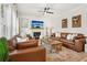 Elegant living room with leather furniture, fireplace, and rustic accents creating a warm ambiance at 5305 Redfield Way, Cumming, GA 30028