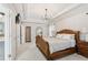 Spacious main bedroom featuring trey ceilings, chandelier, and a large wooden bed frame at 5305 Redfield Way, Cumming, GA 30028