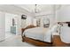 Main bedroom features a large bed, chandelier, and access to the ensuite bath at 5305 Redfield Way, Cumming, GA 30028