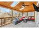 Inviting screened patio with wood ceiling, comfortable seating, and view to the wooded backyard at 5305 Redfield Way, Cumming, GA 30028