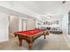 Expansive recreation room with a pool table, comfortable seating, and neutral carpeting at 5305 Redfield Way, Cumming, GA 30028