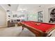 Relaxing recreation room featuring a pool table, sofa, and a projector with a screen at 5305 Redfield Way, Cumming, GA 30028