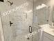 Modern glass shower with grey accent tiles and black hardware, with a small shower seat at 5720 Urban Village Way # 7, Tucker, GA 30084