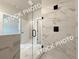 A contemporary primary bathroom features a glass shower and doorway to another room at 5720 Urban Village Way # 7, Tucker, GA 30084