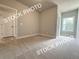 Bedroom with neutral carpet, ample light and easy access to other parts of the home at 5720 Urban Village Way # 7, Tucker, GA 30084