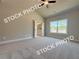 A light filled primary bedroom features carpet, neutral paint and trim, and a view to the yard at 5720 Urban Village Way # 7, Tucker, GA 30084