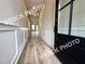 Inviting entryway with board and batten walls and durable laminate flooring leading into the home at 5720 Urban Village Way # 7, Tucker, GA 30084