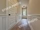 Hallway features board and batten walls and durable laminate flooring at 5720 Urban Village Way # 7, Tucker, GA 30084
