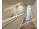 Bright hallway boasts wooden floors, a white banister, and access to other rooms at 5720 Urban Village Way # 7, Tucker, GA 30084