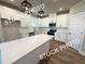 Modern kitchen with white cabinets, stainless steel appliances, and a large island at 5720 Urban Village Way # 7, Tucker, GA 30084