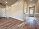 Spacious living room flowing into hallway features durable laminate flooring at 5720 Urban Village Way # 7, Tucker, GA 30084