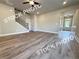 Large living room with adjacent staircase features durable laminate flooring and recessed lighting at 5720 Urban Village Way # 7, Tucker, GA 30084