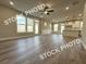 Spacious living room featuring an open floor plan, hardwood floors, and ample natural light at 5720 Urban Village Way # 7, Tucker, GA 30084