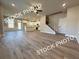 Open-concept living space with kitchen featuring a central island and stainless appliances at 5720 Urban Village Way # 7, Tucker, GA 30084