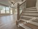 Well-lit staircase with wood treads and decorative railing is located next to the living room at 5720 Urban Village Way # 7, Tucker, GA 30084