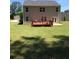 Expansive backyard featuring a deck, lush green grass, and plenty of space for outdoor activities at 9405 Bandywood Dr, Covington, GA 30014