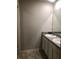 Bathroom featuring double sinks with white cabinets and tile flooring at 9405 Bandywood Dr, Covington, GA 30014