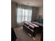 Bright bedroom with large windows, curtains, and a comfortable bed, creating a cozy retreat at 9405 Bandywood Dr, Covington, GA 30014