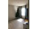 Cozy bedroom with Christmas tree, neutral carpet, and window with patterned curtains at 9405 Bandywood Dr, Covington, GA 30014
