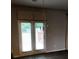 Dining area with French doors to outside, chandelier, and patterned curtains at 9405 Bandywood Dr, Covington, GA 30014