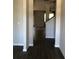 Hallway featuring hard surface floors and views into the dining and Gathering room at 9405 Bandywood Dr, Covington, GA 30014