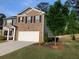 Beautiful house with a well-maintained lawn, a two-car garage, and a mix of brick and siding at 9405 Bandywood Dr, Covington, GA 30014
