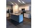 Well-equipped kitchen with a center island, stainless steel appliances, and white cabinetry for a modern look at 9405 Bandywood Dr, Covington, GA 30014