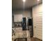 Modern kitchen featuring stainless steel appliances, granite countertops, white cabinets and a water dispenser at 9405 Bandywood Dr, Covington, GA 30014