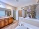 Well-lit bathroom with a double vanity, walk-in shower, and a soaking tub at 2826 Staunton Dr, Duluth, GA 30097