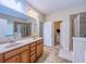 Bathroom showcasing a double vanity, tile floors, large mirror, and a walk-in closet at 2826 Staunton Dr, Duluth, GA 30097