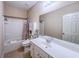 Bright bathroom features a tub/shower combo, single sink vanity, and neutral color palette at 2826 Staunton Dr, Duluth, GA 30097