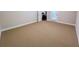 Bedroom featuring carpeted floors, base molding, an exit door, and natural light at 2826 Staunton Dr, Duluth, GA 30097