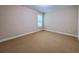 Neutral bedroom featuring carpeted floors, base molding and natural light through a large window at 2826 Staunton Dr, Duluth, GA 30097