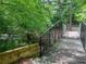 Picturesque community wooden bridge with black metal safety rails crosses a stream at 2826 Staunton Dr, Duluth, GA 30097