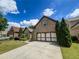 Well-maintained brick home with a spacious driveway and an attached two-car garage at 2826 Staunton Dr, Duluth, GA 30097