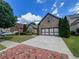 Lovely brick home with a wide driveway, a two-car garage, and beautifully landscaped front yard at 2826 Staunton Dr, Duluth, GA 30097