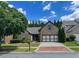 Desirable brick home featuring a driveway with brick trim, a two-car garage, and mature landscaping at 2826 Staunton Dr, Duluth, GA 30097