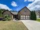 Attractive brick home with a spacious driveway, a two-car garage, and well-maintained landscaping at 2826 Staunton Dr, Duluth, GA 30097