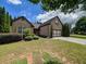 Charming brick home with lush landscaping, a well-manicured lawn, and a two-car garage at 2826 Staunton Dr, Duluth, GA 30097